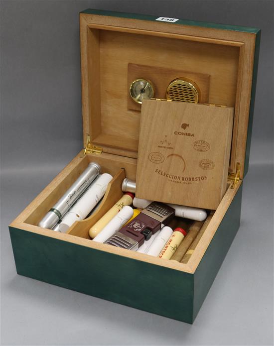 A green stained birds eye maple humidor containing a selection of cigars